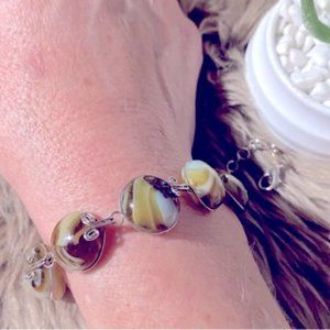 Multi coloured bracelet with scroll design?